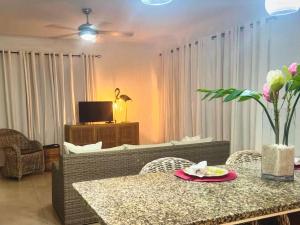 a living room with a table and a couch at Palm Oasis Bonaire in Kralendijk