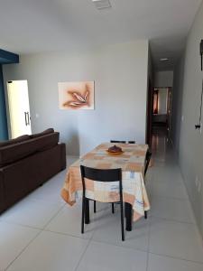 a dining room with a table and a couch at Comfort right on the sand! in Paracuru