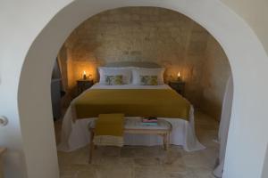 a bedroom with a large bed and a table at Masseria Celeste in Fasano