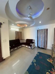 a living room with a couch and a blue ceiling at The 9th Oasis in Hyderabad