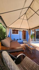 a bedroom with a large bed and a patio at Recanto da Dona Luiza - Pousada in Florianópolis