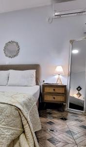 a bedroom with a bed and a mirror at Meltemaki in Mouzákion