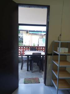 a door leading into a dining room with a table at Cabugao guest house in El Nido