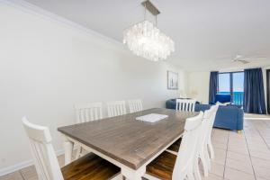 a dining room and living room with a table and chairs at Phoenix X 504 in Orange Beach