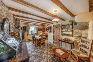 a living room with a stone wall and a table and chairs at 4 Bed in Arthog oc-b31966 in Arthog