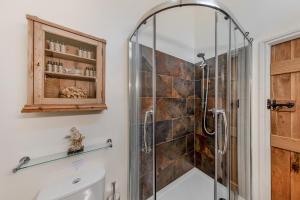 a shower in a bathroom with a glass shower stall at 4 Bed in Arthog oc-b31966 in Arthog +41 photos