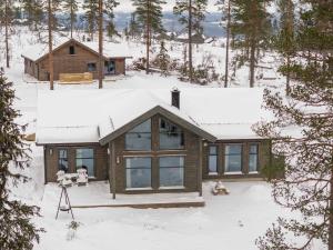a house in the snow with a camera at TH2124- Spacious ski-in out cabin in Trysilfjell with 5 bedrooms in Hovi