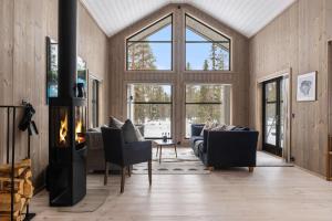 a living room filled with furniture and a fireplace at TH2124- Spacious ski-in out cabin in Trysilfjell with 5 bedrooms in Hovi