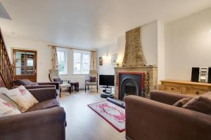 a living room with two couches and a fireplace at 3 Bed in Leyburn oc-ds013 in West Witton