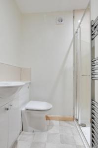 a white bathroom with a toilet and a sink at 3 Bed in Leyburn oc-ds013 in West Witton +6 photos