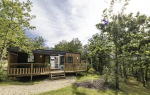 a cabin in the woods with a porch and trees at ZEcamping 4 étoiles animaux acceptés piscine couverte in Loupiac