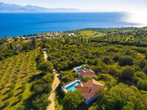 an aerial view of a house on a hill next to the ocean at Villa Calliope Kalamaki in Kalamaki