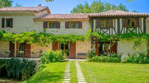 a stone house with a pathway in front of it at Gîte le Moulin Samsara in Homps