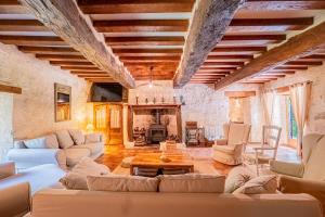 a large living room with couches and a fireplace at Gîte le Moulin Samsara in Homps