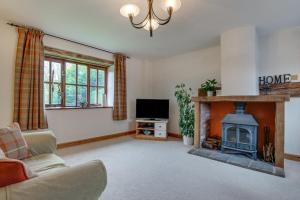 a living room with a fireplace and a tv at 2 Bed in Exminster oc-h28725 in Exminster