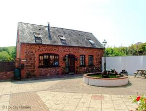 a brick building with a fountain in front of it at 2 Bed in Exminster oc-h28725 in Exminster