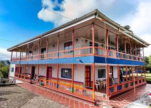 a large building with orange and blue trim at Mirador Verde By Nala in Circasia