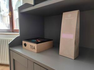 a box sitting on top of a counter next to a shelf at in Piazza in Mezzocorona