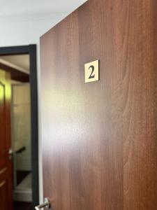 a wooden door with the number two on it at Complex SummerTime in Cavnic +21 photos