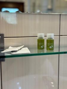 two glasses of green liquid sitting on a glass counter at Complex SummerTime in Cavnic