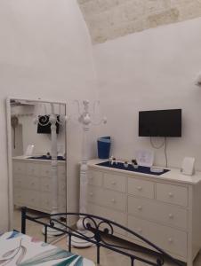 a bedroom with a dresser and a mirror at Maison della Madia in Triggiano