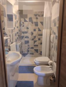 a bathroom with a toilet and a sink at Maison della Madia in Triggiano +20 photos
