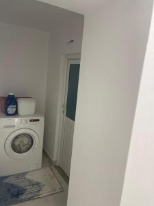 a laundry room with a washing machine and a washer at Peaceful House in Përmet