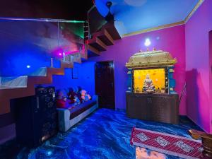 a room with a fish tank and a staircase at selvis casa in Pondicherry