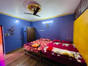 a bedroom with a bed and a blue wall at selvis casa in Pondicherry