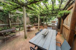 an outdoor patio with a wooden table and chairs at James Buchanan Hotel, Trademark Collection by Wyndham in Mercersburg