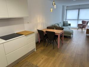 a kitchen and living room with a table and a couch at 60m2 Cozy Apartament in Valencia