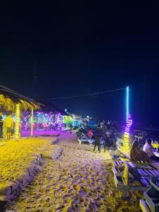 a beach at night with people sitting on chairs at Baga Sea shine in Baga +35 photos