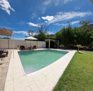 a swimming pool in the backyard of a house at La cañada in Belén