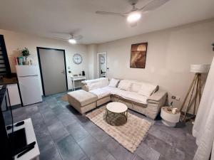 a living room with a couch and a table at Les Douces Nuits Saint Pierre in Saint-Pierre
