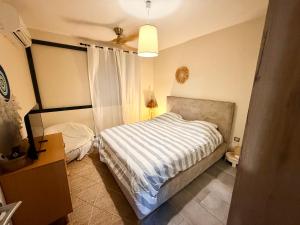 a bedroom with a bed and a ceiling at Les Douces Nuits Saint Pierre in Saint-Pierre