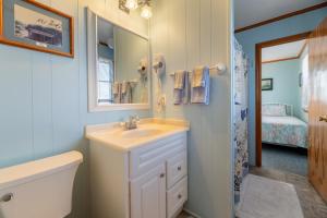 a bathroom with a sink and a toilet and a mirror at Desi's Delight - S Nags Head MP 20.5, Ocean View, 30 Yards to Beach, Cargo Lift, YR Flex Stays in Nags Head +64 photos