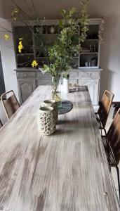 a dining room table with a vase on it at Willert hauss in La Cumbrecita +3 photos