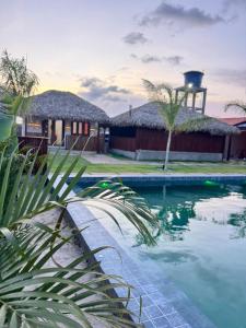a villa with a swimming pool in front of a house at POUSADA AMORIM in Santo Amaro