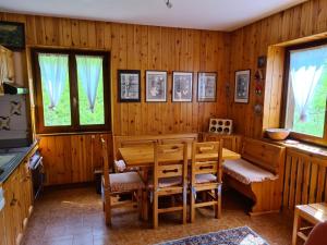 a dining room with a wooden table and chairs at Ca' Delle Nevi in SantʼAntonio