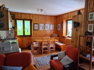 a living room with a dining room table and chairs at Ca' Delle Nevi in SantʼAntonio