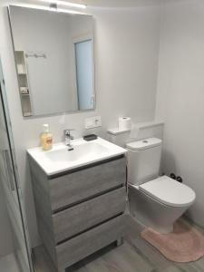 a bathroom with a sink and a toilet and a mirror at Ca l'Agüela -Fontanars dels Alforins in Fontanares +32 photos
