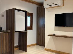 a room with a flat screen tv and a wall at Arkeon Bosphorus Hotel & Suites in Istanbul