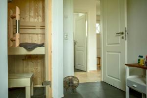 a hallway with a door leading to a room at Reethaus "Buntspecht" in Zierow +12 photos