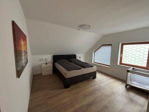 a bedroom with a bed and two windows at Ferienhaus an der Burg Coraidelstein in Klotten +33 photos