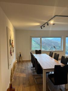 a dining room with a long table and chairs at Ferienhaus an der Burg Coraidelstein in Klotten