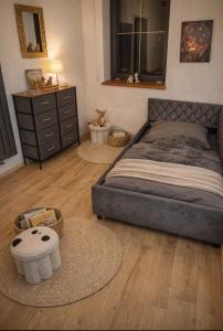 a bedroom with a bed and a dresser and two rugs at Chalet Woidzauber in Zwiesel