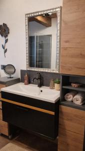 a bathroom with a sink and a mirror at Chalet Woidzauber in Zwiesel +16 photos
