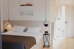 a bedroom with a bed with white sheets and pillows at White Villa, Brac in Splitska +29 photos