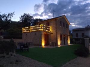 a building with lights on the side of it at Casale Parvil in Monteprandone +27 photos