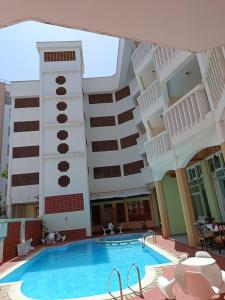a large building with a swimming pool in front of it at Raya hotel Nyali Mombasa in Mombasa +18 photos